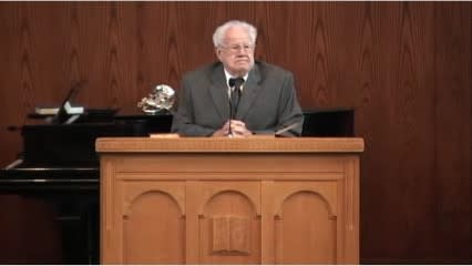 man standing at podium speaking at DTS Chapel