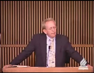 man standing at podium speaking at DTS Chapel