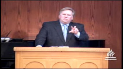 man standing at podium speaking at DTS Chapel