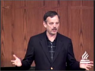 man standing at podium speaking at DTS Chapel