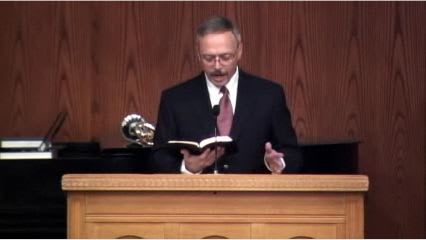 man standing at podium speaking at DTS Chapel
