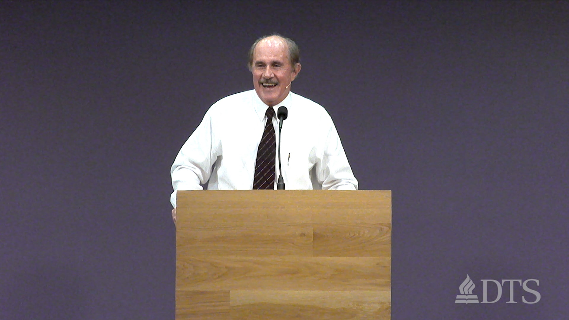 man standing at podium speaking at DTS Chapel