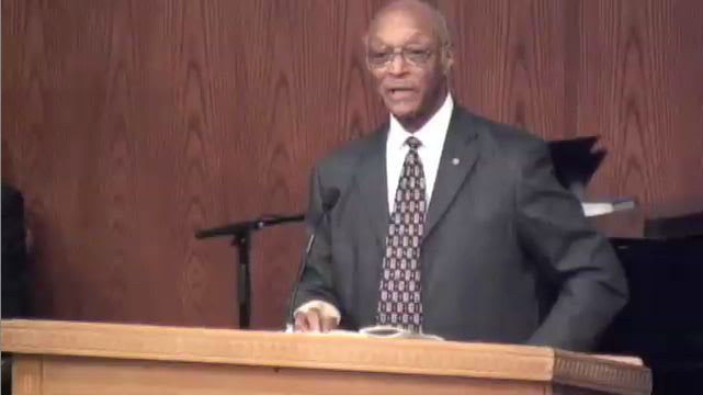 man standing at podium speaking at DTS Chapel
