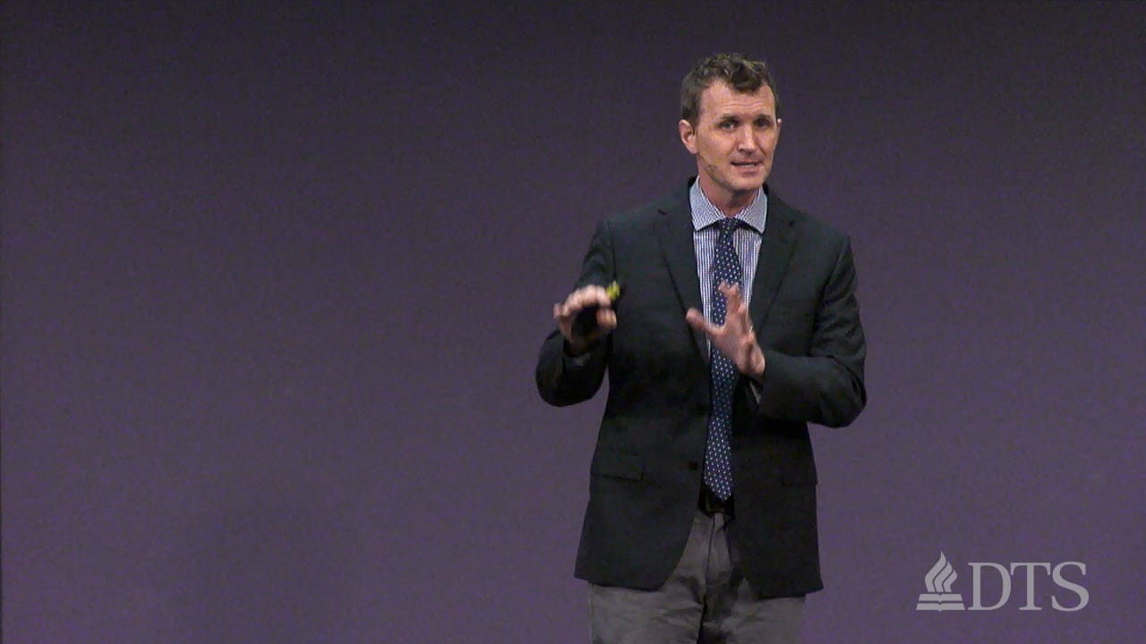 man standing on stage while speaking at DTS Chapel