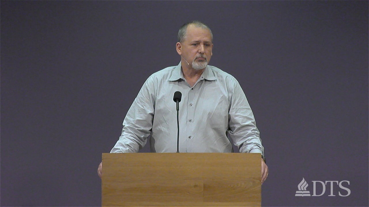 Dr. Glenn Kreider standing at podium speaking at DTS Chapel