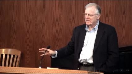 man standing at podium speaking at DTS Chapel