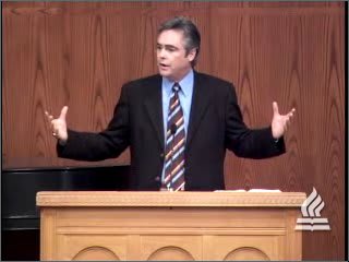 man standing at podium speaking at DTS Chapel