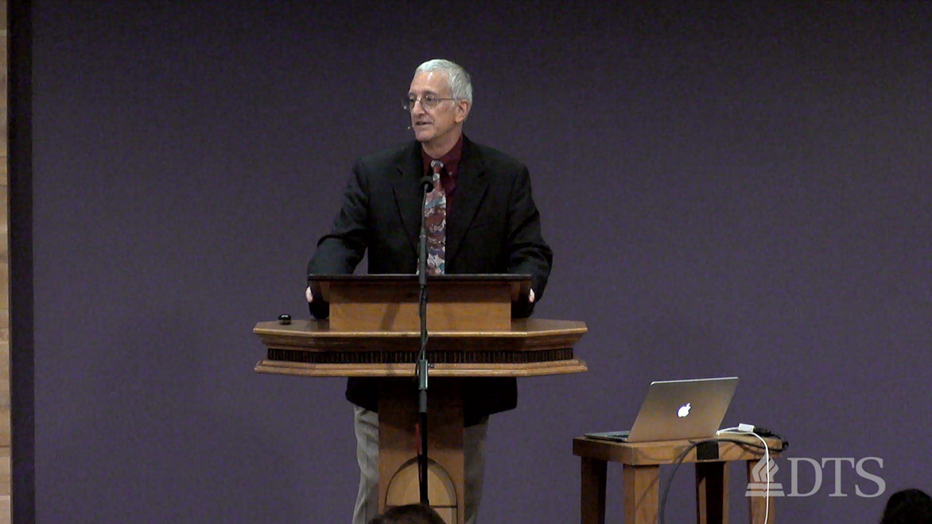 man standing at podium speaking at DTS Chapel