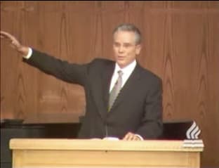 man standing at podium speaking at DTS Chapel