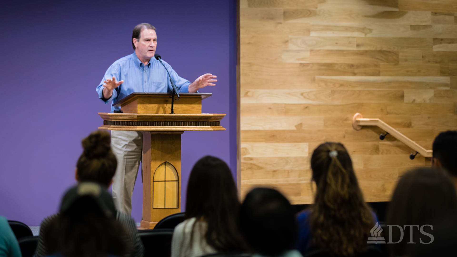 man standing at podium speaking at DTS Chapel