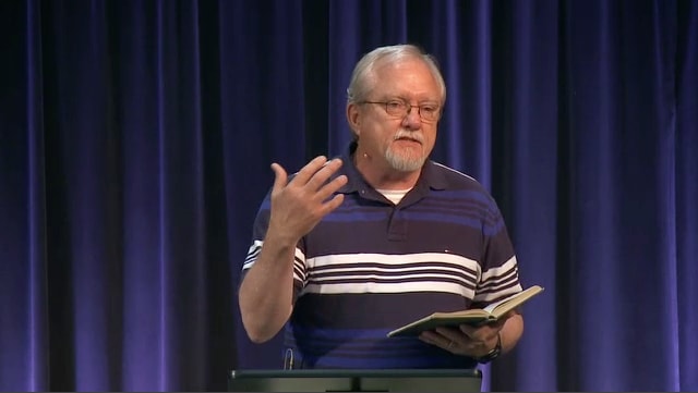 man standing at podium speaking at DTS Chapel