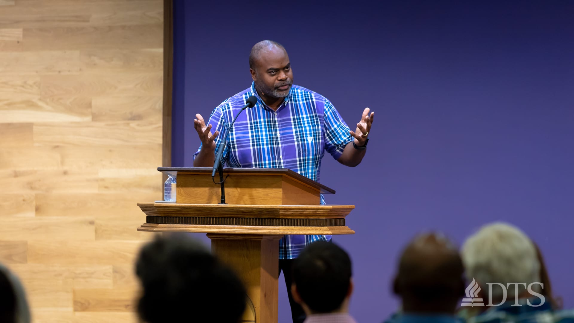man standing at podium speaking at DTS Chapel
