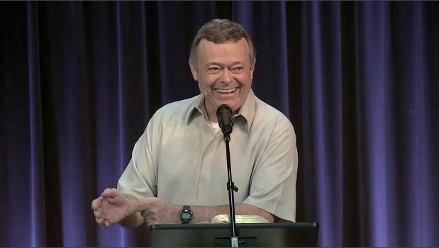 man standing at podium speaking at DTS Chapel