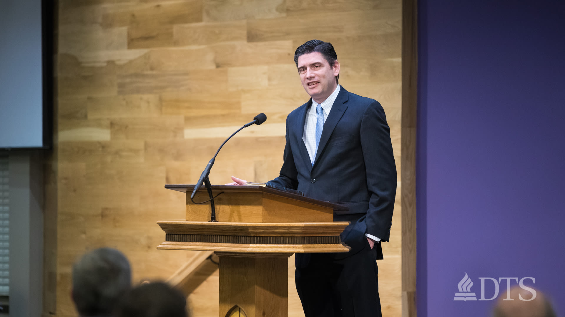 man standing at podium speaking at DTS Chapel