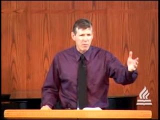 man standing at podium speaking at DTS Chapel