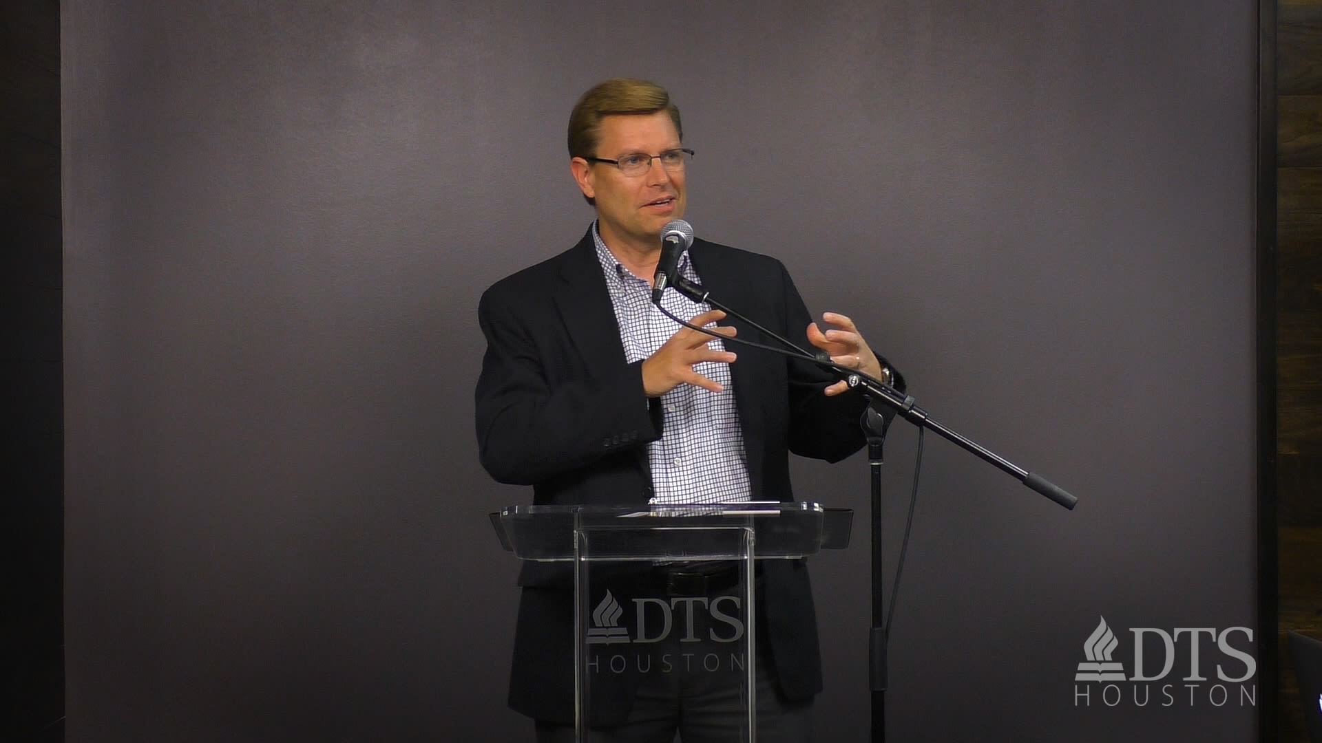 man standing at podium speaking at DTS Chapel