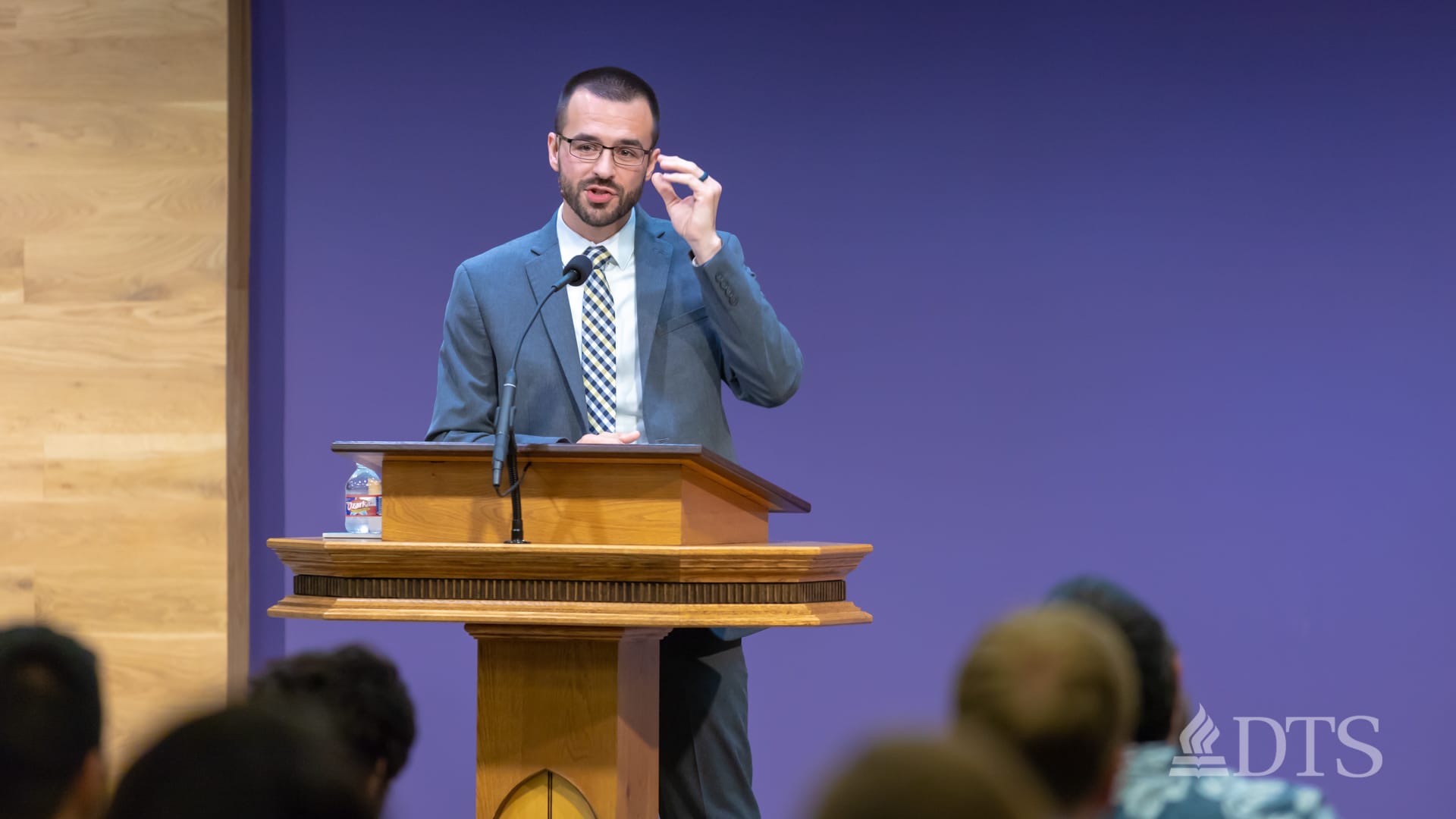 man standing at podium speaking at DTS Chapel