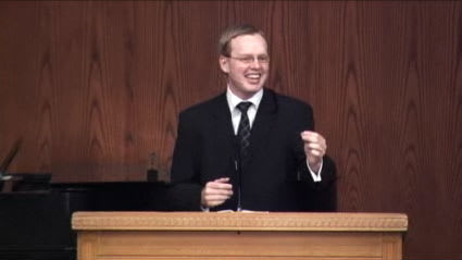 man standing at podium speaking at DTS Chapel
