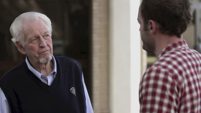 Bill Bryan outside on DTS campus listening to a man