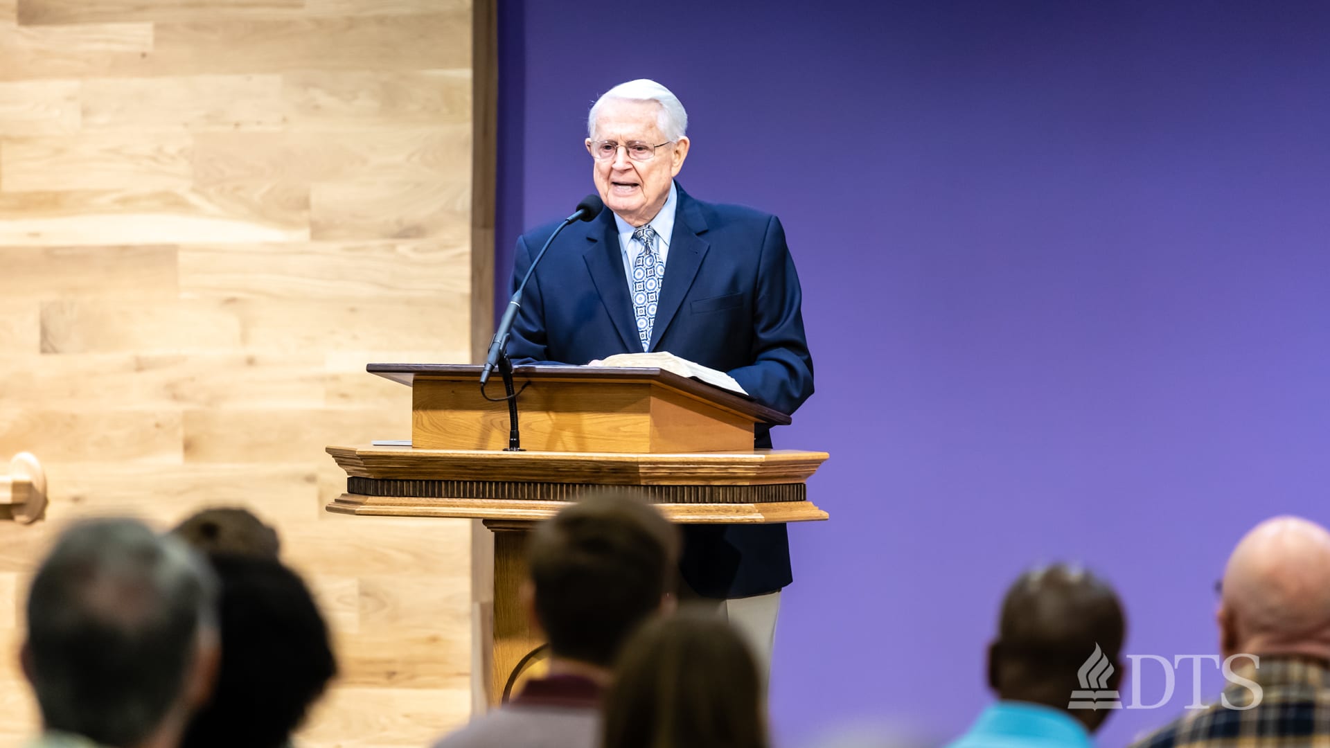 Dr. Chuck Swindoll standing at podium speaking at DTS Chapel