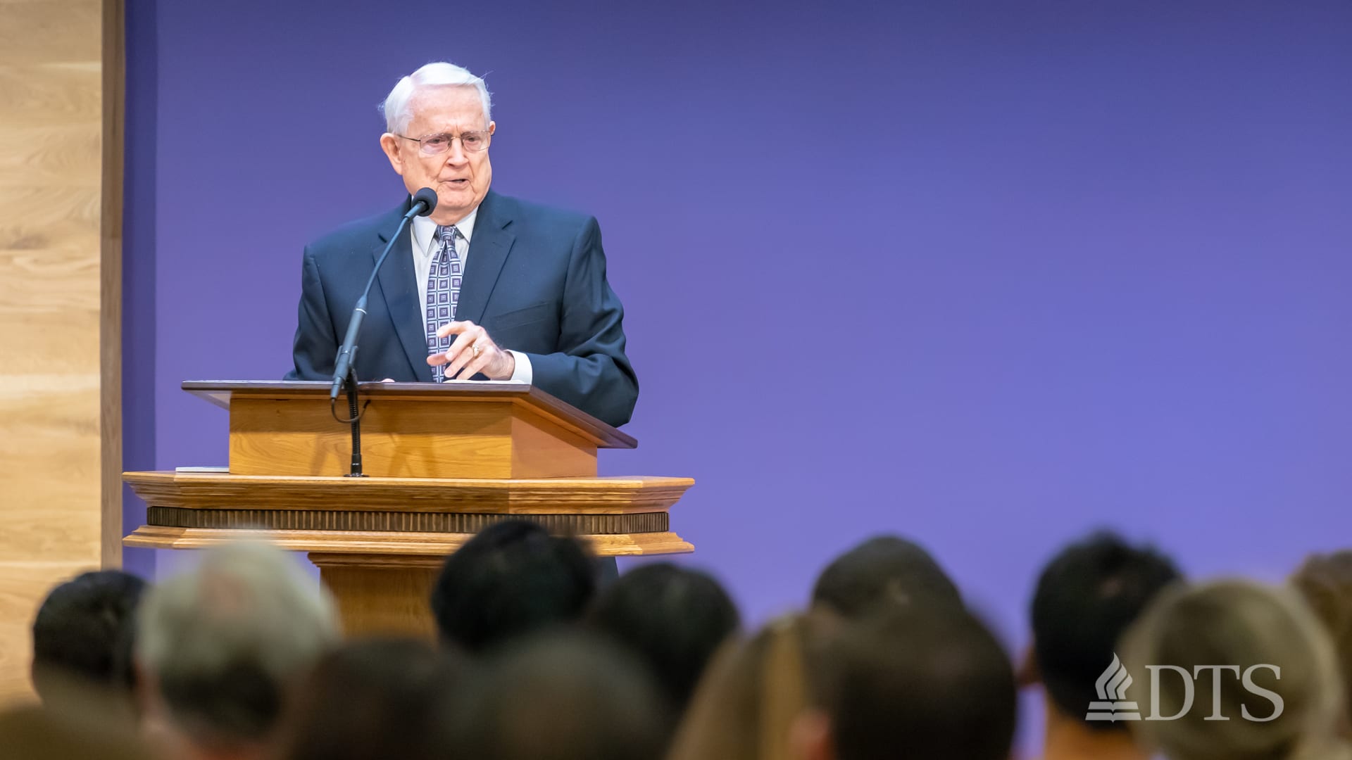 Dr. Chuck Swindoll standing at podium speaking at DTS Chapel
