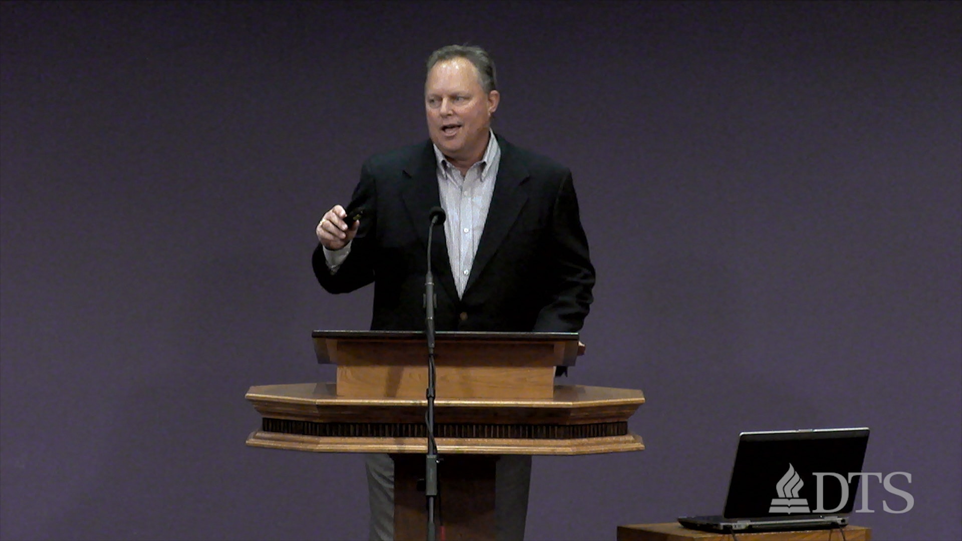 man standing at podium speaking at DTS Chapel