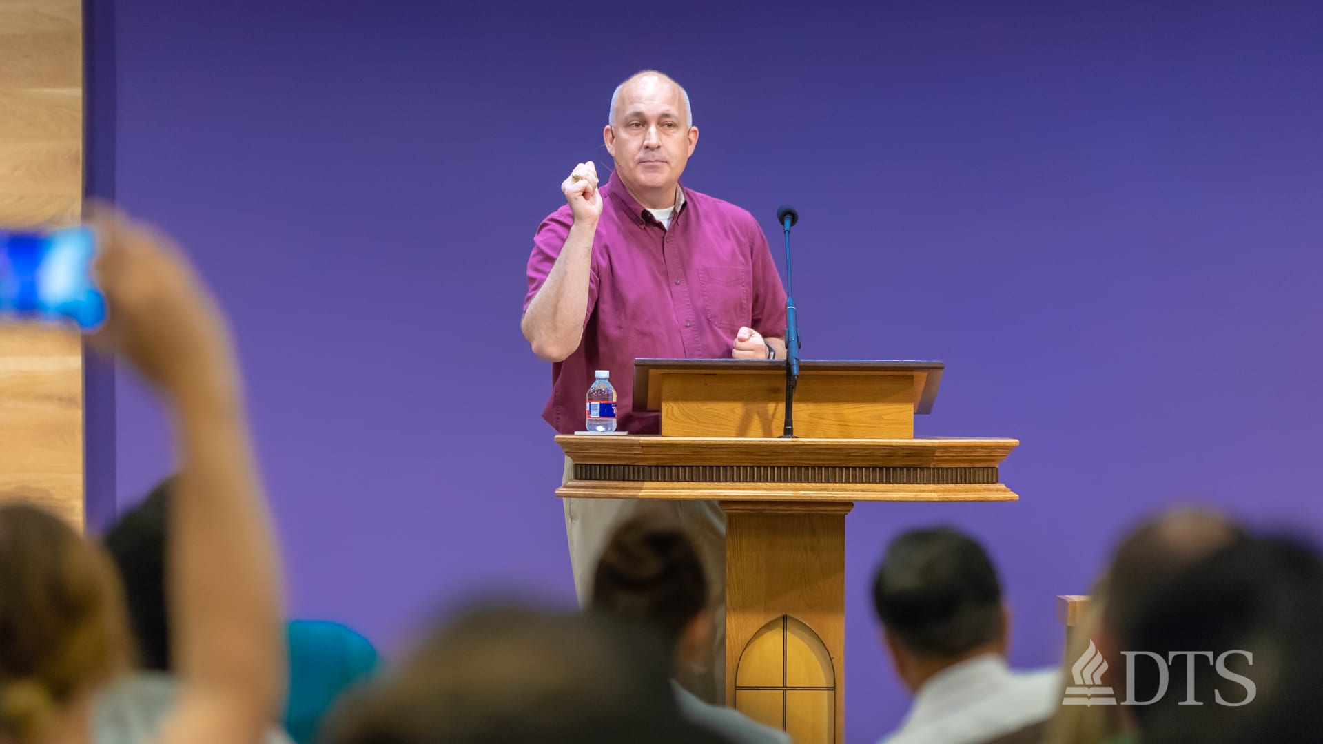 man standing at podium speaking at DTS Chapel