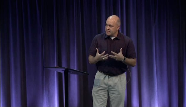 man standing at podium speaking at DTS Chapel