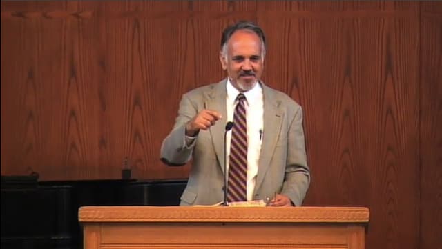 man standing at podium speaking at DTS Chapel