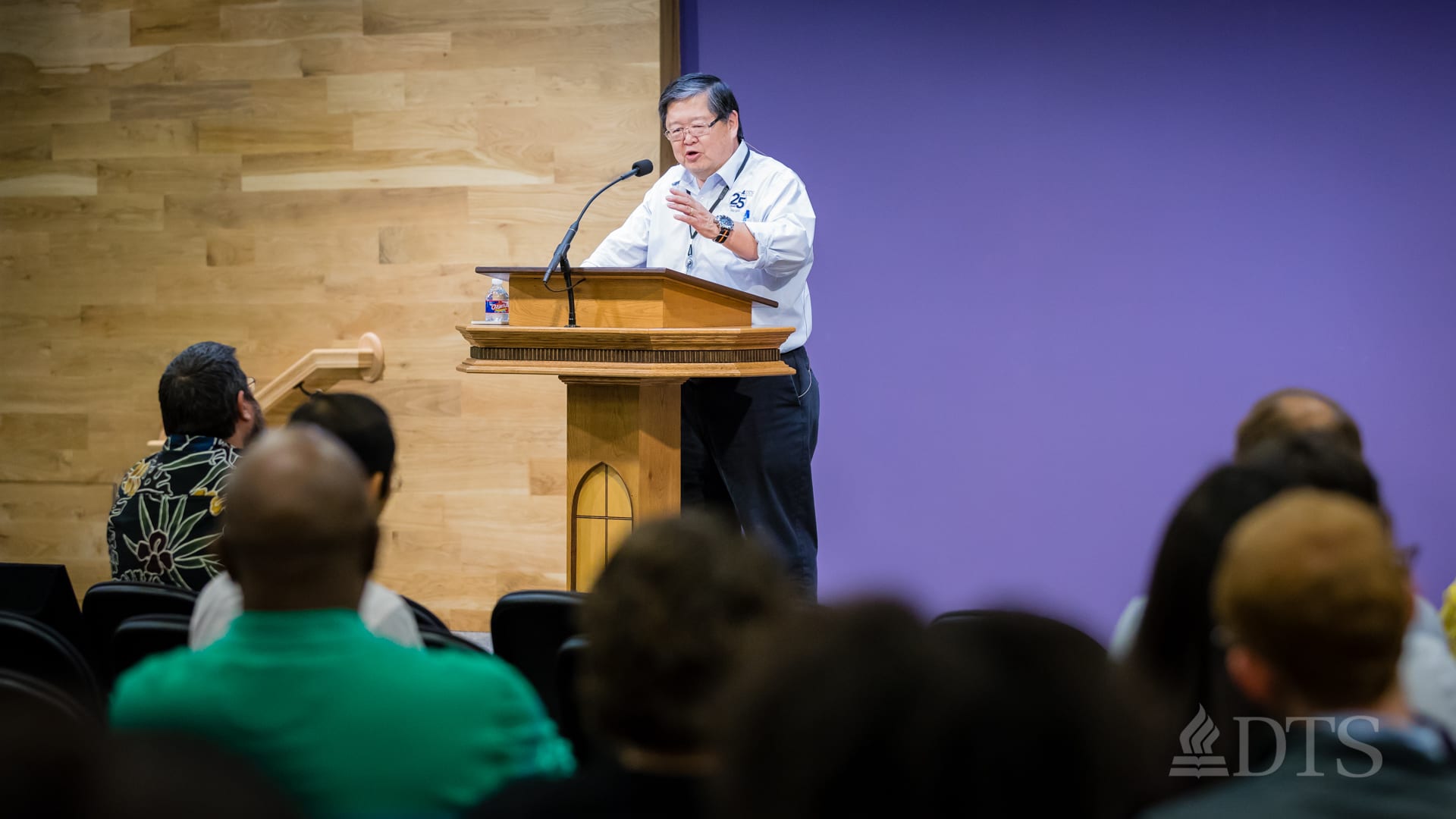 man standing at podium speaking at DTS Chapel