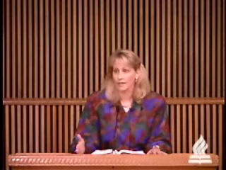 woman standing at podium speaking at DTS Chapel