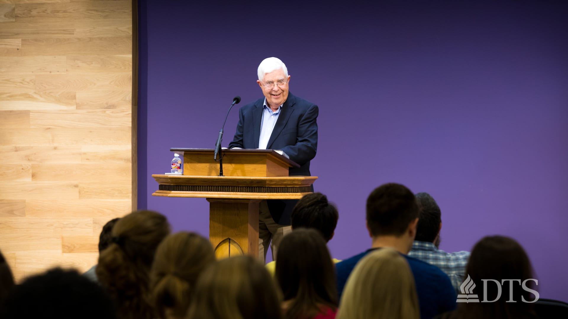 man standing at podium speaking at DTS Chapel