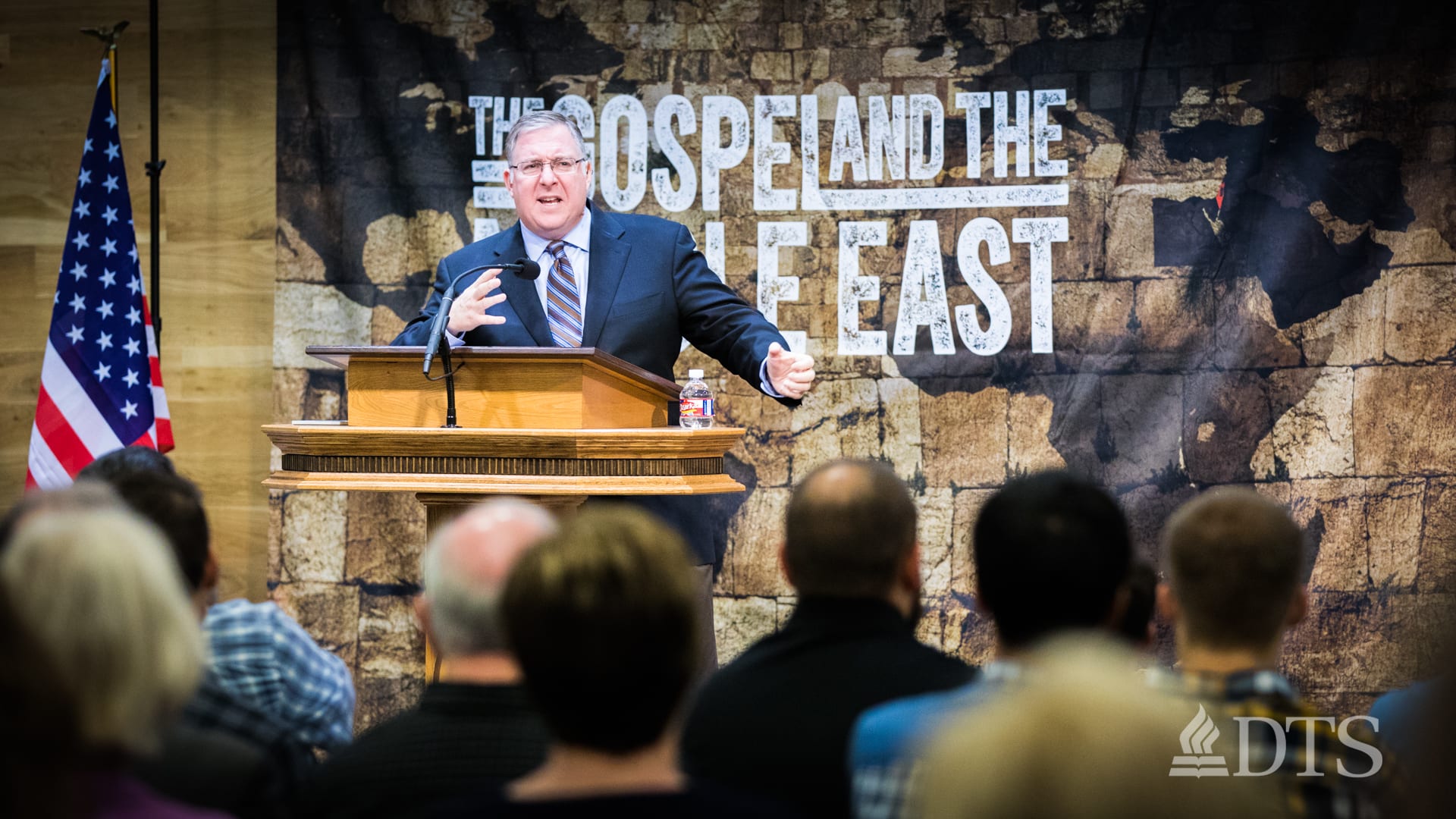 man standing at podium speaking at DTS Chapel
