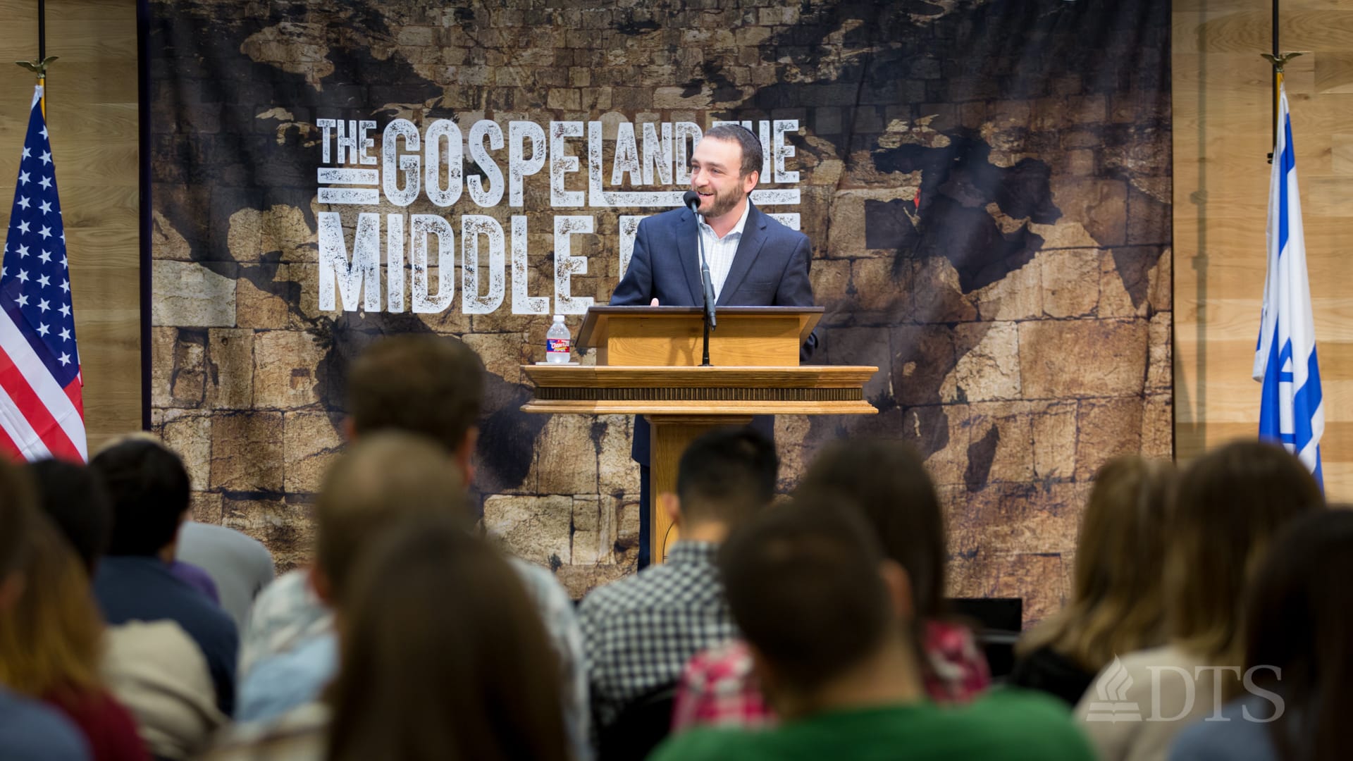 man standing at podium speaking at DTS Chapel