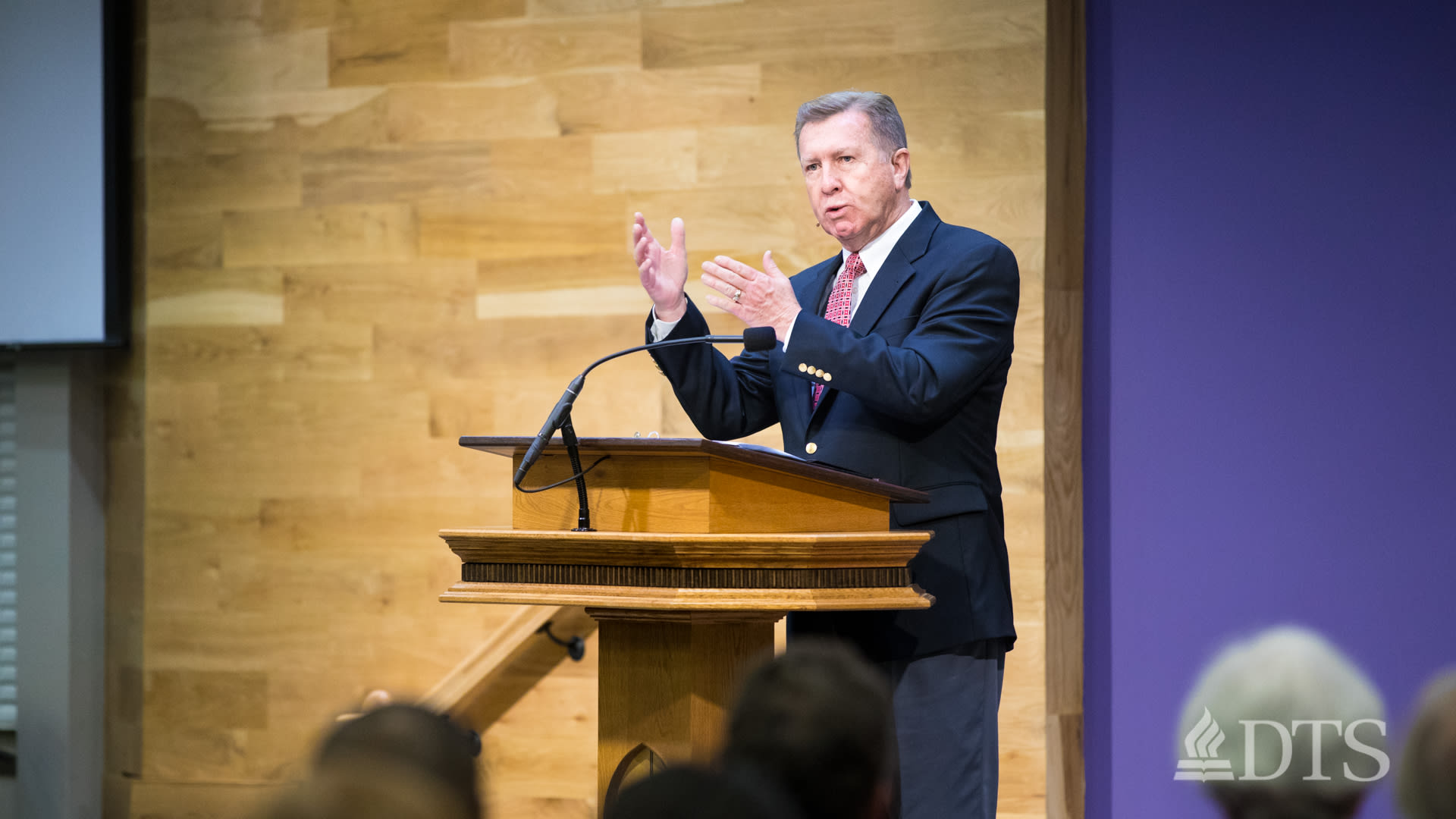 man standing at podium speaking at DTS Chapel