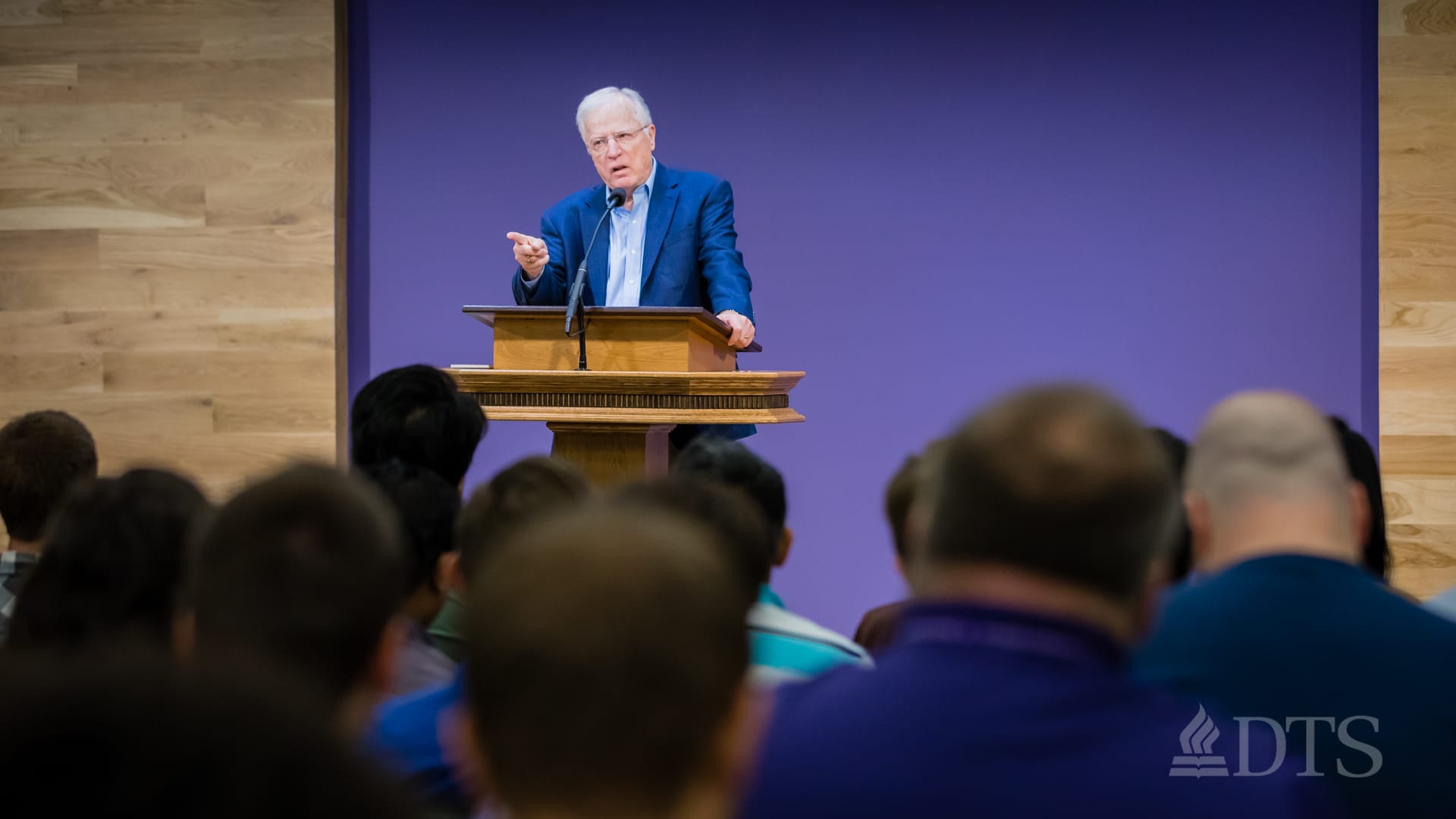 man standing at podium speaking at DTS Chapel