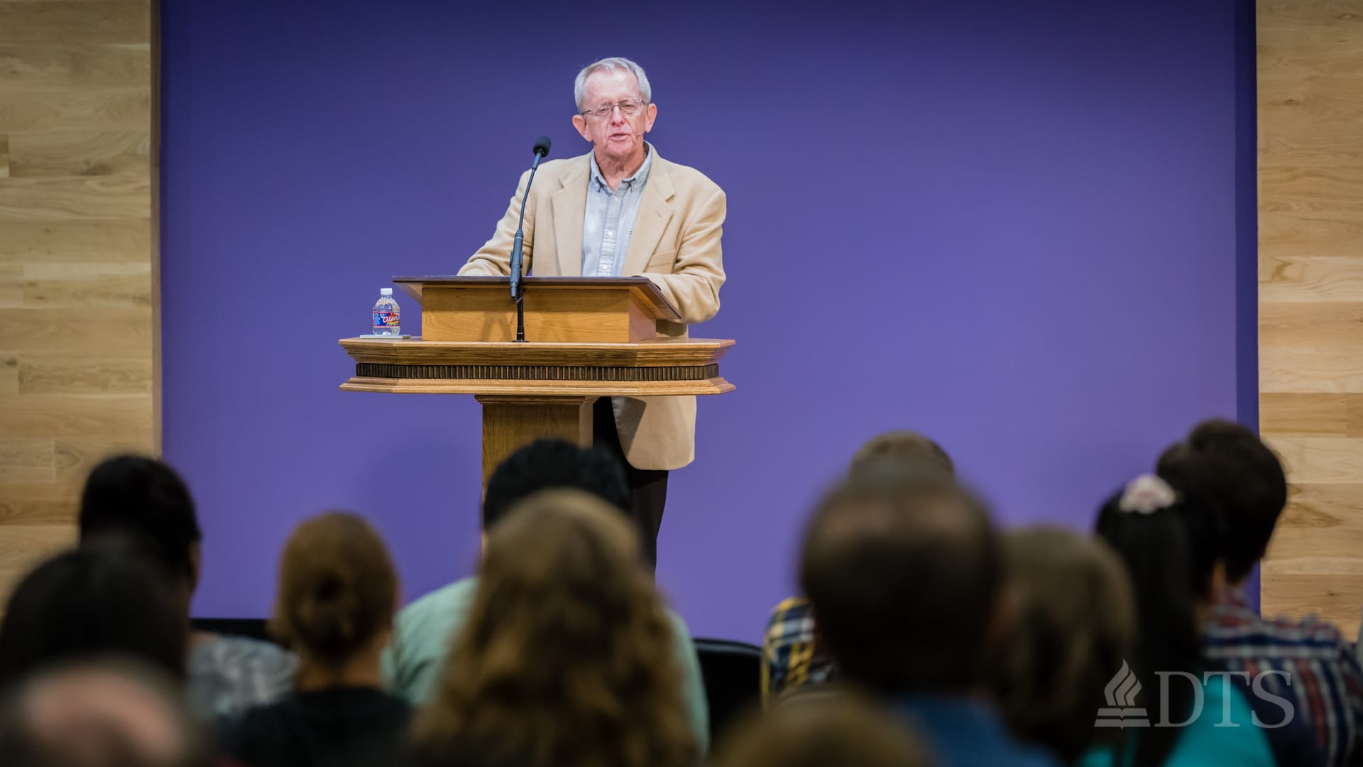 Dr. John Hannah standing at podium speaking at DTS Chapel