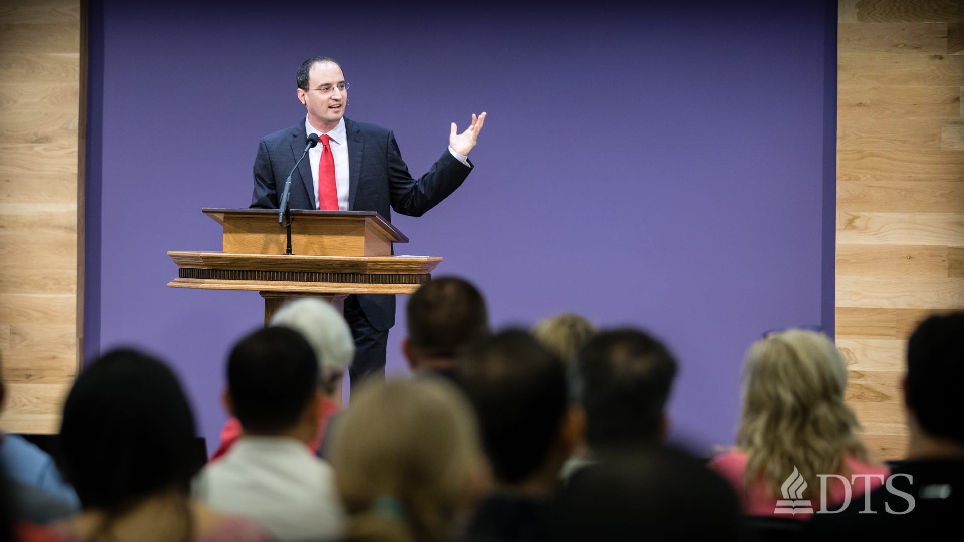 man standing at podium speaking at DTS Chapel
