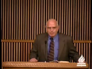 man standing at podium speaking at DTS Chapel