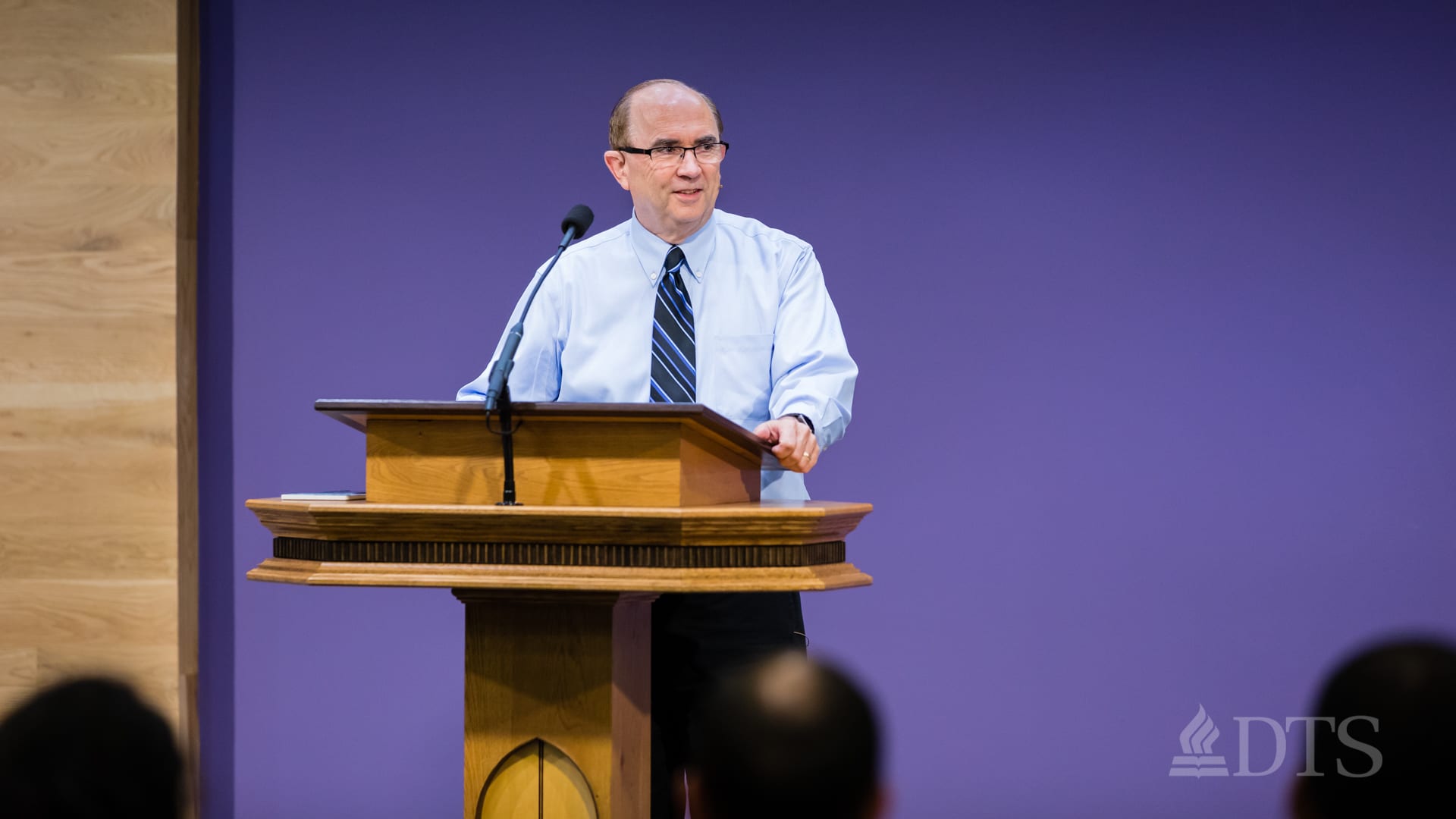 man standing at podium speaking at DTS Chapel