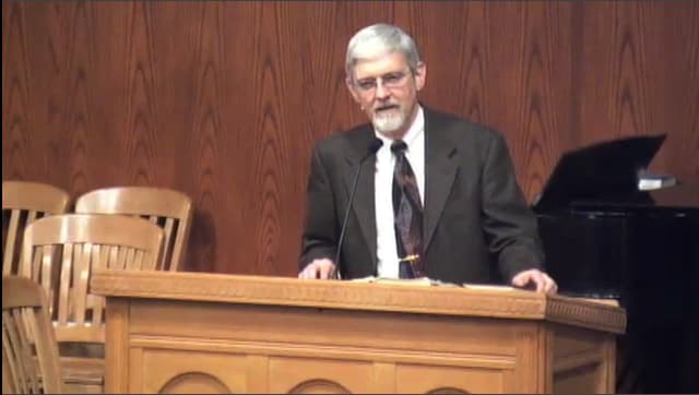 man standing at podium speaking at DTS Chapel