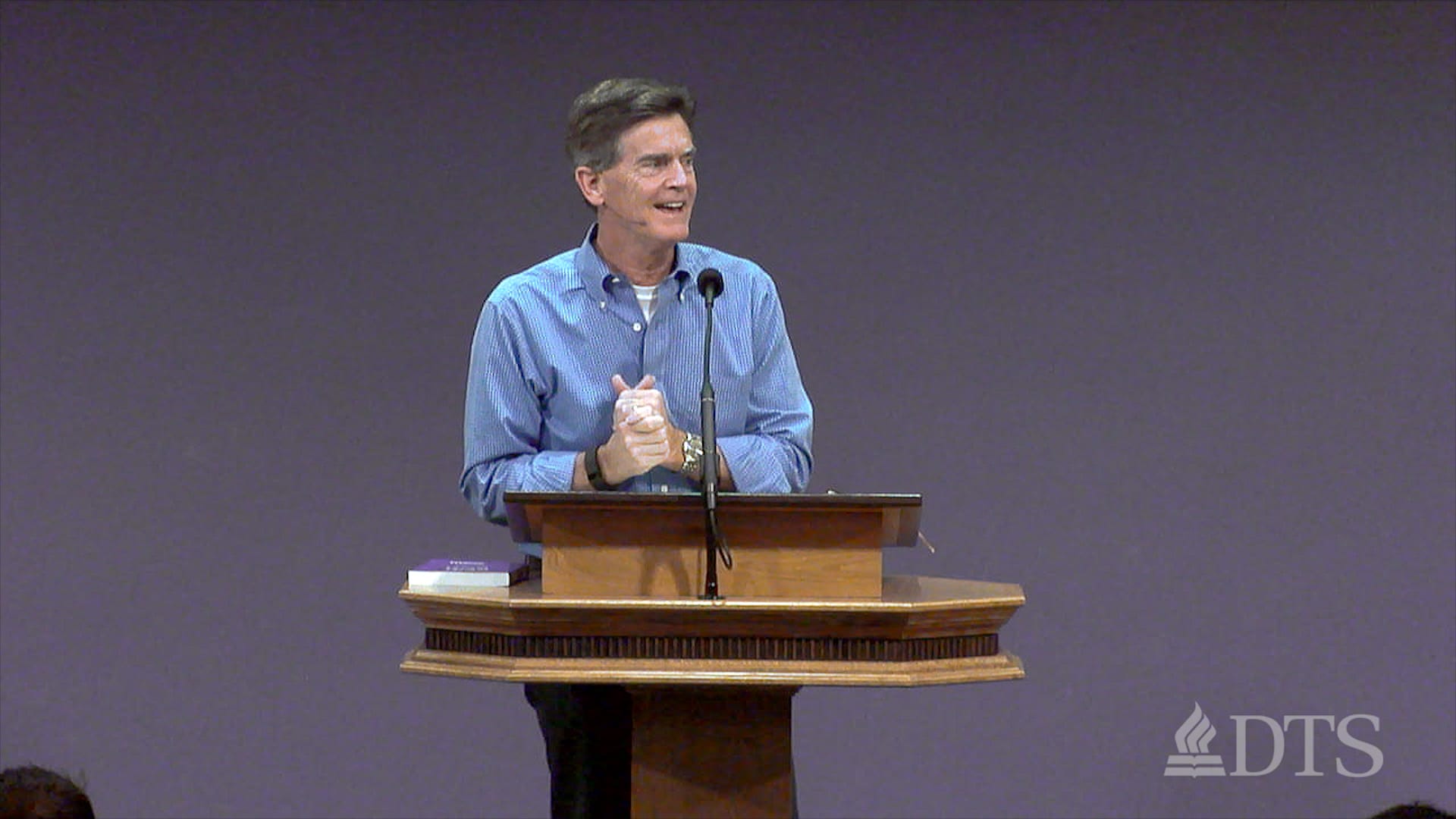 man standing at podium speaking at DTS Chapel