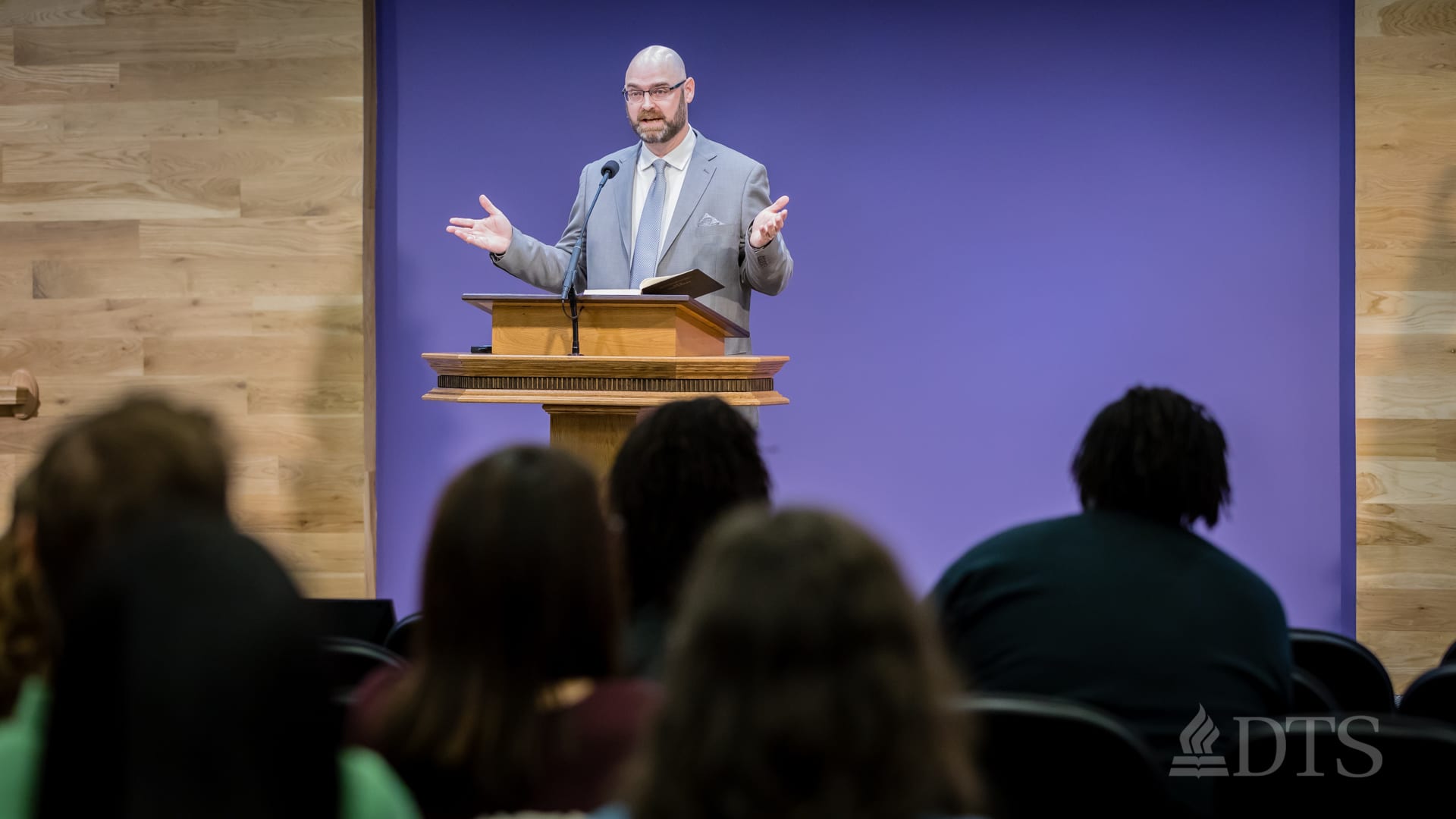 man standing at podium speaking at DTS Chapel