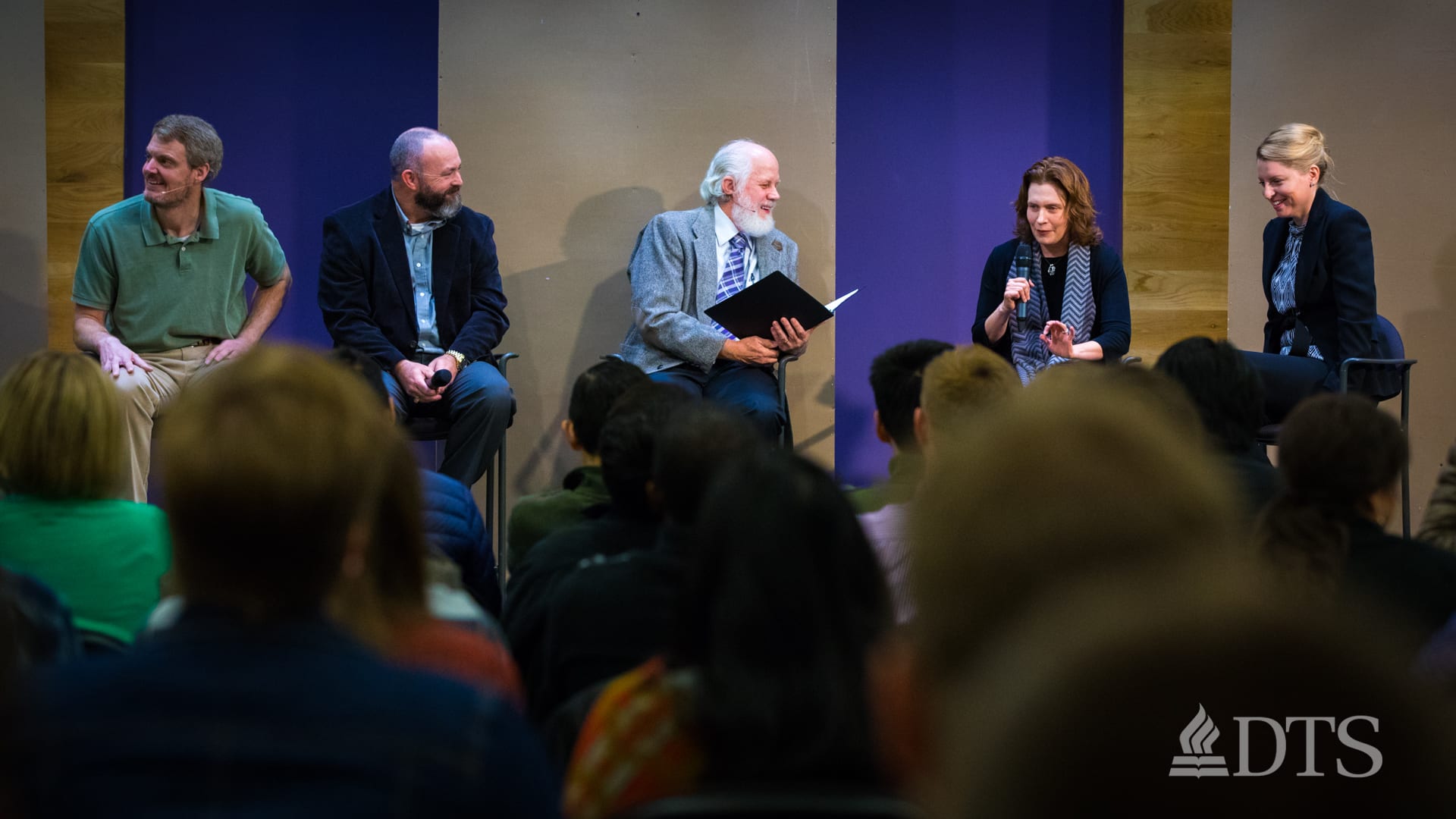 men and women seated on stage in panel discussion during DTS Chapel