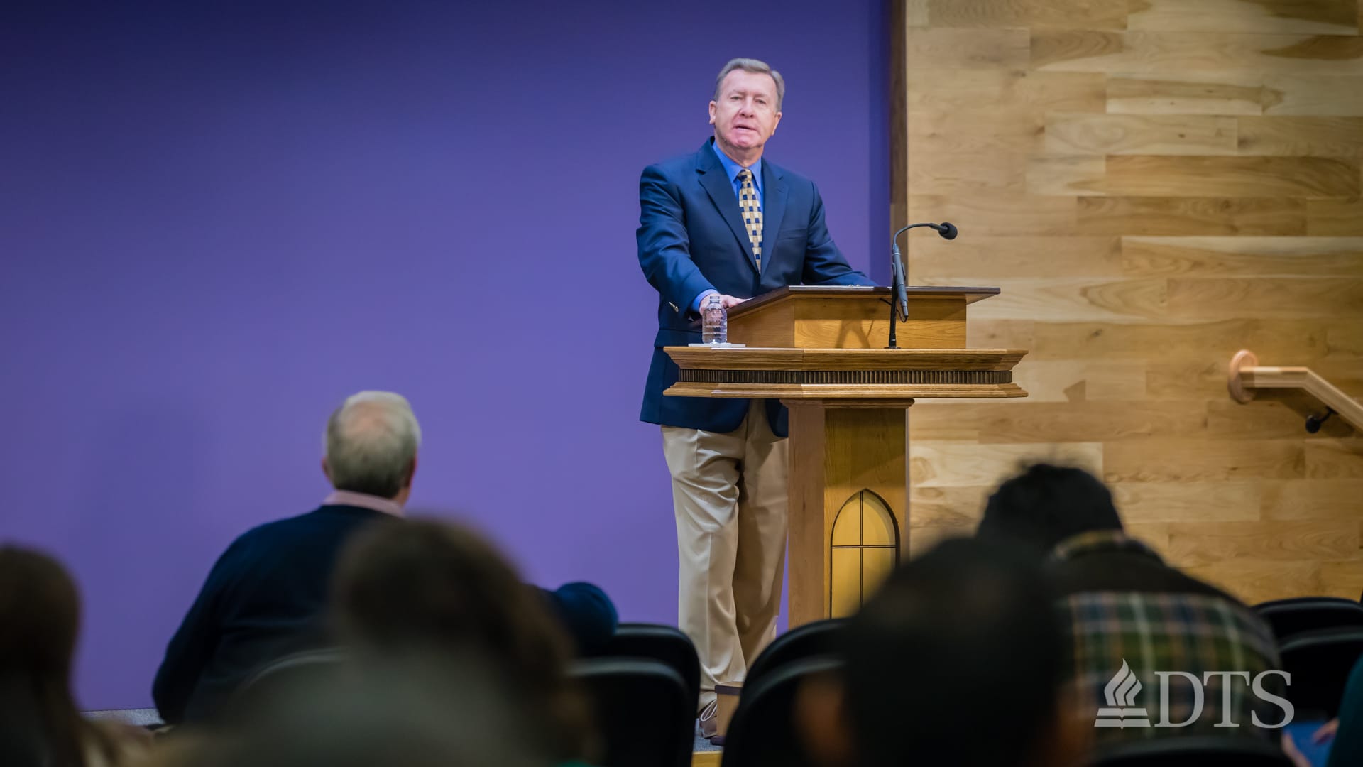 man standing at podium speaking at DTS Chapel