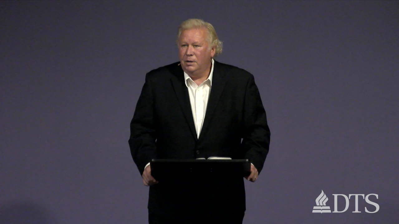 man standing at podium speaking at DTS Chapel