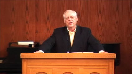 man standing at podium speaking at DTS Chapel