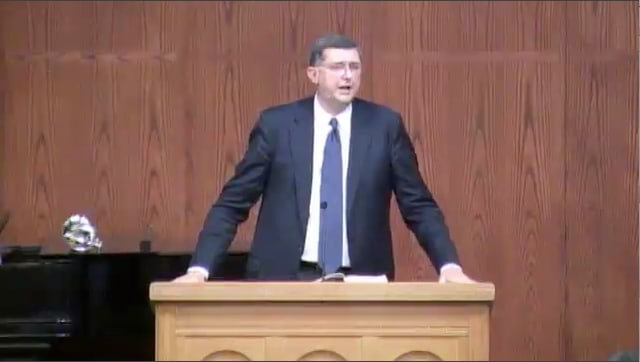 man standing at podium speaking at DTS Chapel