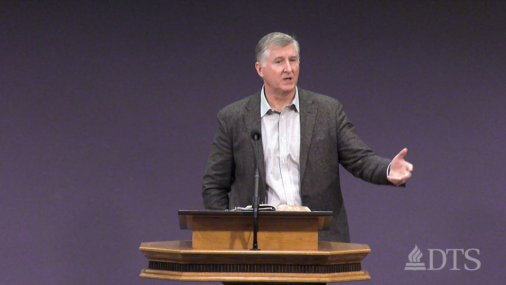 man standing at podium speaking at DTS Chapel
