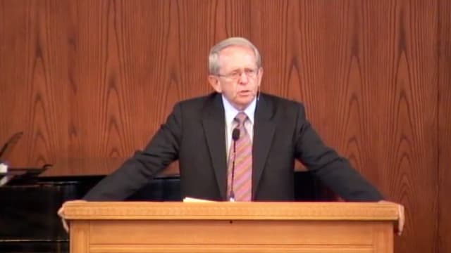 Dr. John Hannah standing at podium speaking at DTS Chapel